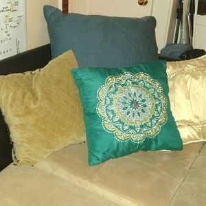Teal mandala-designed throw pillow